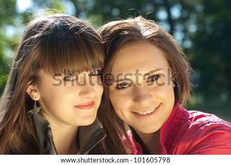 Two happy young women head shot