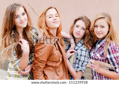 Four happy teenage girls friends outdoors happy smiling and having fun