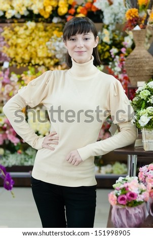 Young beautiful happy smiling female lady woman working in flower shop
