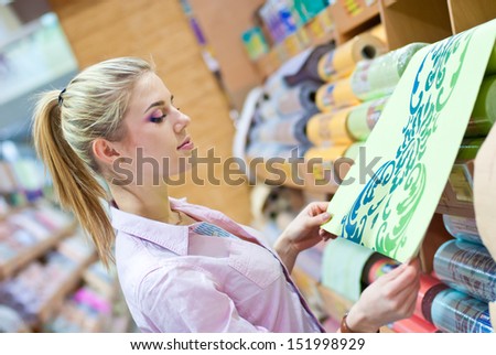 Woman with rolls of wallpaper