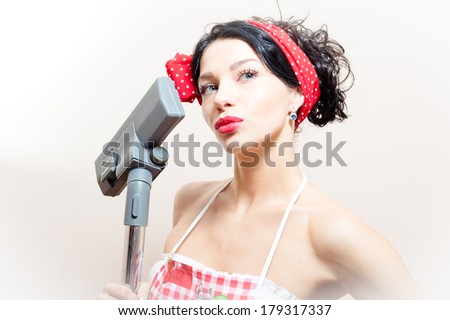 beautiful funny young black haired blue eyes pinup woman with vacuum cleaner