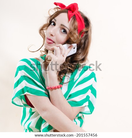 picture of speaking on mobile cell phone showing tongue funny sexy pinup girl blond young beautiful woman having fun posing studio shot over white wall copy space background portrait