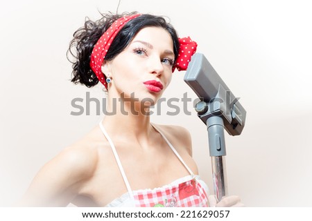 beautiful funny young black haired blue eyes pinup woman with vacuum cleaner