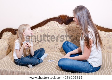 Picture of young pretty woman and little girl playing cards