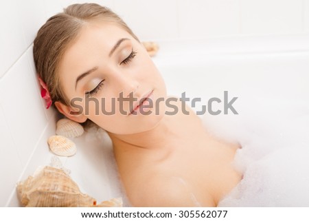 Young lovely woman in foam bath