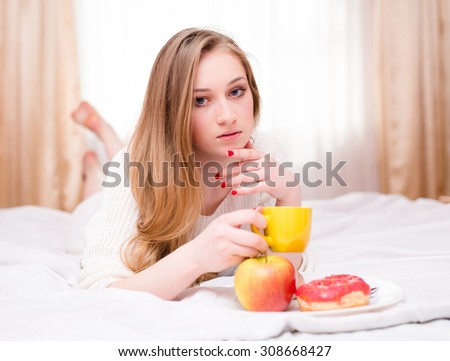 Picture of sad beautiful sensual young woman having coffee
