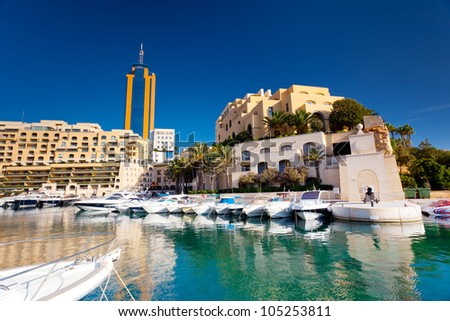 Fantastic city landscape on the seaside with boats. Portomaso Business Tower, Malta.