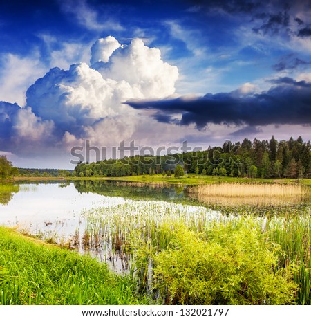 Fantastic landscape with lake and dramatic sky. Overcast sky. Carpathian, Ukraine, Europe. Beauty world.