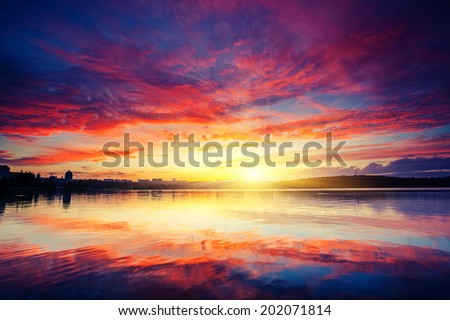 City in twilight. Fantastic colorful sunset and dark ominous clouds. Ternopil, Ukraine, Europe. Beauty world.