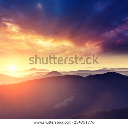 Majestic sunset in the mountains landscape with sunny beams. Dramatic scene. Carpathian, Ukraine, Europe. Beauty world. Retro style, vintage filter. Instagram toning effect.
