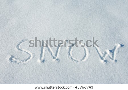 writing text SNOW on the snow