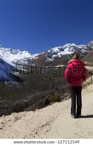 Tsopta Valley, Sikkim - India. Woman looking out across the mountains.