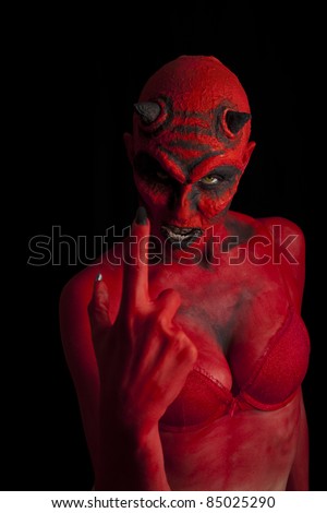 Sexy red devil woman beckoning you over, black background.