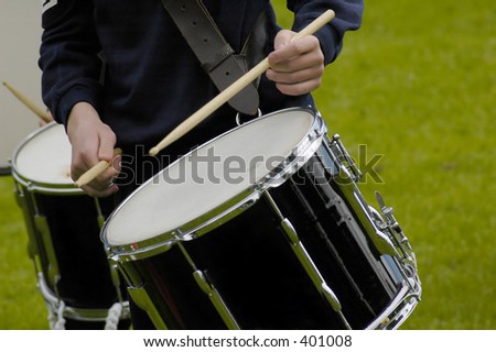 Boy drumming in a marching band