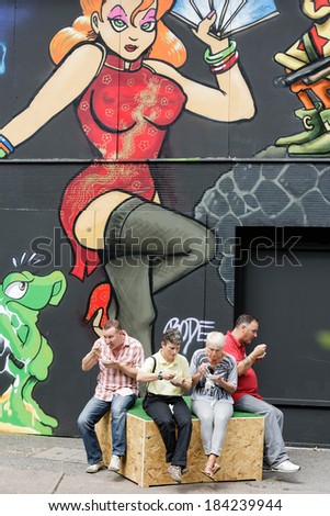 BRISTOL, UK - AUGUST 18: Visitors enjoy a break while visiting the See No Evil street art exhibition on August 18, 2013 in Bristol, UK.