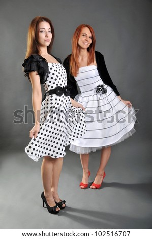 Two beautiful woman in a cocktails dress
