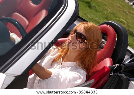 The young woman in the car with rudder