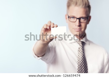 Friendly businessman presenting white empty business card with space for text, isolated.