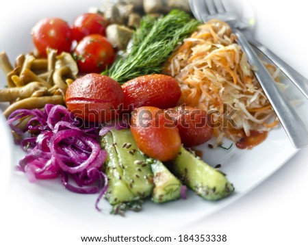 salad of different vegetables, beets, cucumbers, tomatoes and cabbage with mushrooms