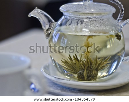 brewed flower green Chinese tea in a glass makers
