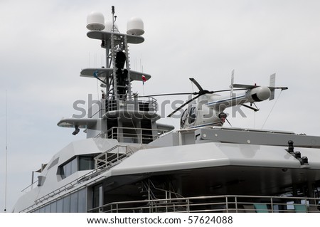 Helicopter on a big yacht with a cloudy sky