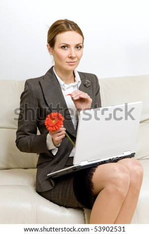 young attractive business woman with a  laptop and red flower