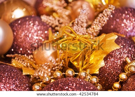 Golden christmas gift box with shiny baubles