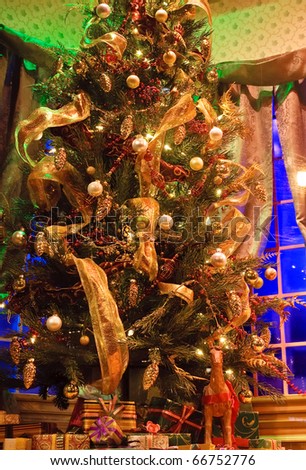 Decorated christmas tree with gift boxes in storefront window