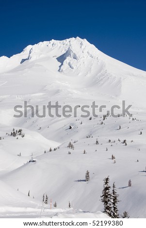 Beautiful Vista of Mount Hood in the Pacific Northwest with Blue Skies and the wind blowing through the snow.