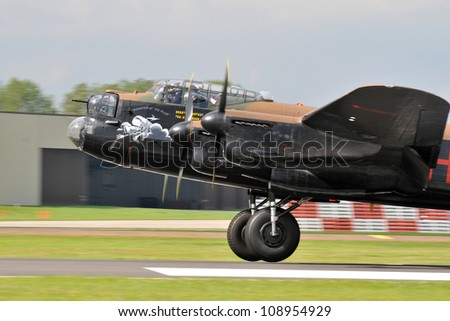 FAIRFORD, UK - JULY 8: Royal Air Force Lancaster Bomber aircraft participates in the Royal International Air Tattoo airshow event July 8, 2012 near Cirencester, England.