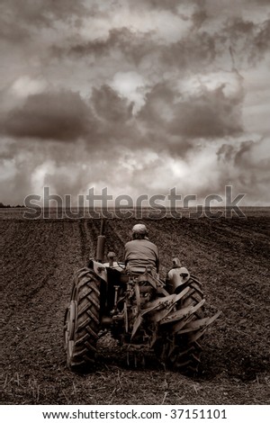Old tractor ploughing a field