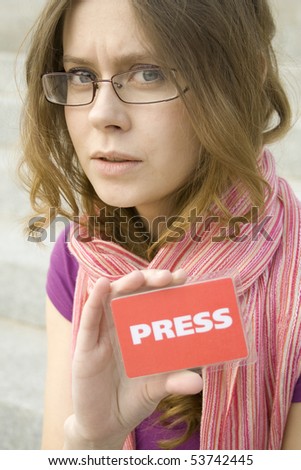 Beautiful woman journalist with a PRESS card