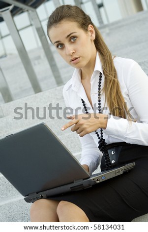 Business woman running on a laptop and was surprised points his finger to a computer