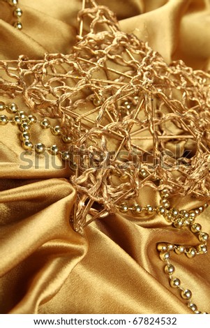 On gold fabric are gold ornaments and Christmas Gold Star. Background
