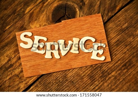 the German word SERVICE ( service ) on wood