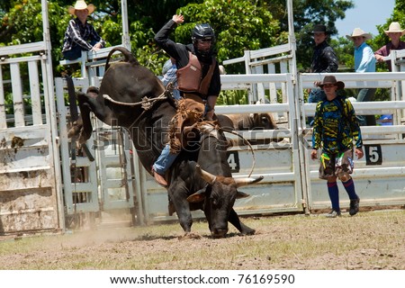 GOLD COAST, AUSTRALIA - JANUARY 26: Unidentified cowboy run away from dangerous bull on January 26,2011 in Gold Coast, Queensland, Australia. The rodeo show was part of Australia Day celebration