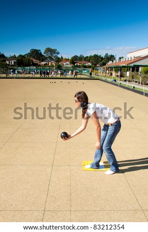 young woman plays lawn bowling in the afternoon (queensland, australia)
