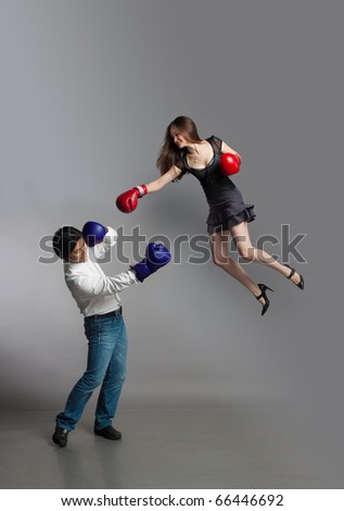 Boxing match between flying girl and guy.