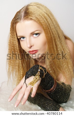 Portrait of sexy young women with gold accessories