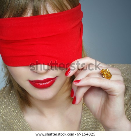 Portrait of a woman with covered eyes. Red lips and manicure