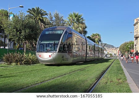 NICE FRANCE - AUGUST 25: Modern tram in the center of Nice France on August 25 2013. For a long stretch of the tram tracks emerge from grass.