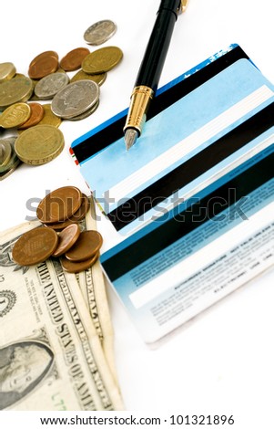 Bank cards, coins and dollars to the lying pen isolated on white background