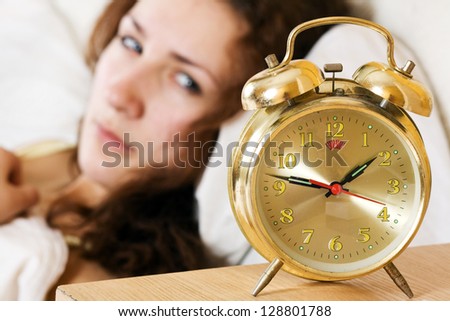 Clock with sleep at night. Woman can not sleep.