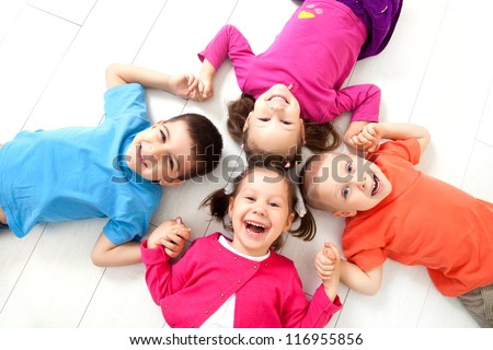 Four kids are on the floor together. Top view