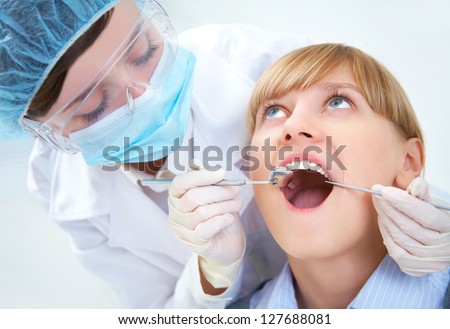 Female teeth being checked by doctor
