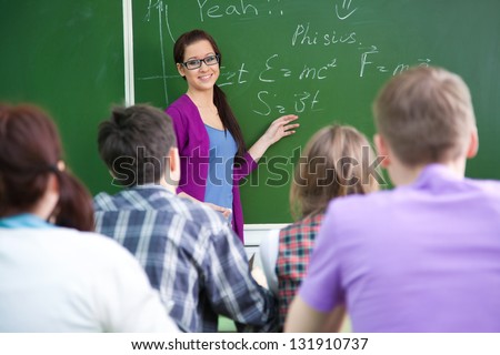 young woman-teacher conducts lessons with a group of students