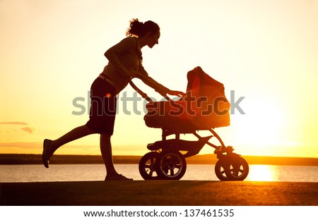 Silhouette of  young mother enjoying motherhood