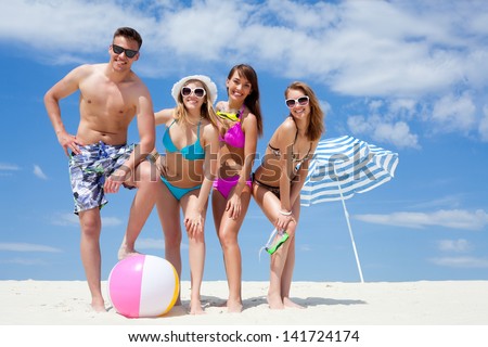 Young fun people are having good time on the beach