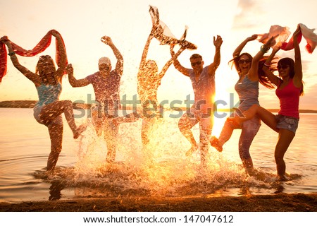 Large group of young people enjoying a beach party