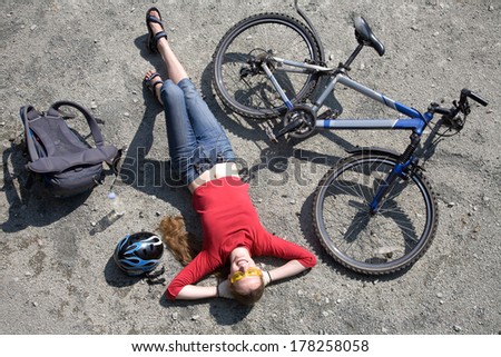 woman  cyclist resting near bike in summertime